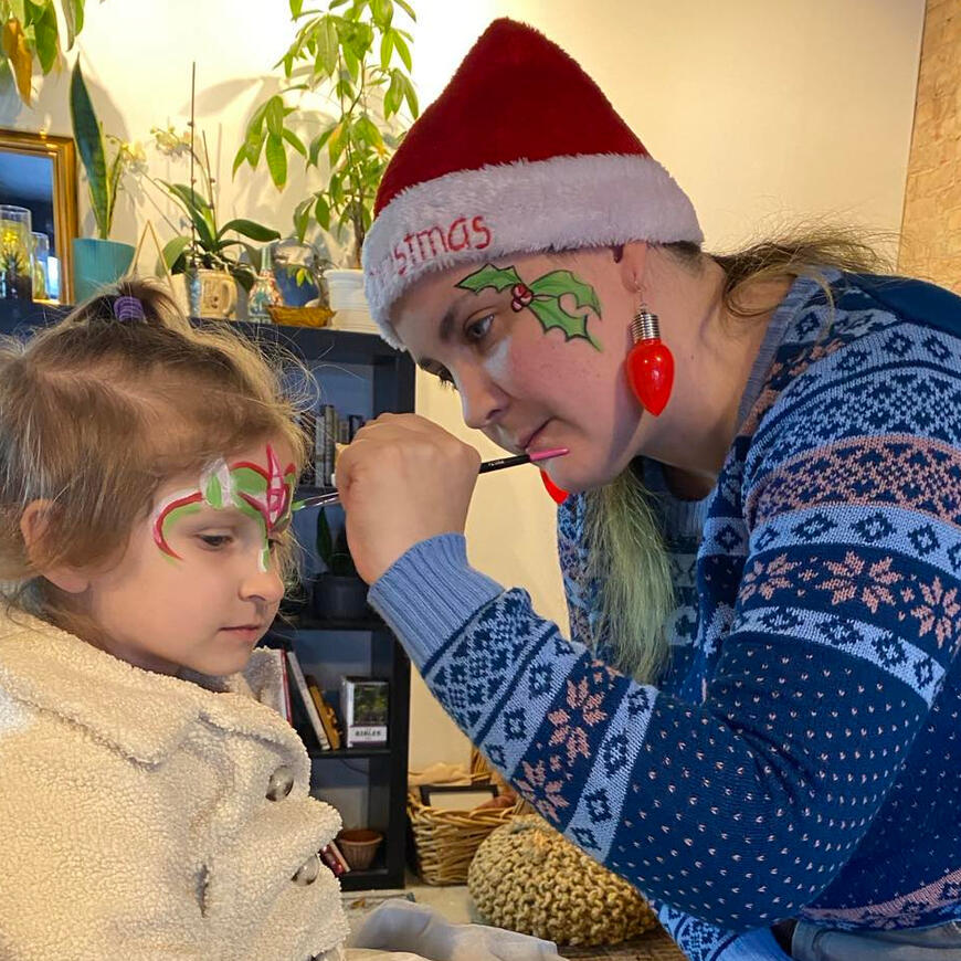 young girl being painted as a unicorn